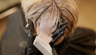 woman applying hair relaxer